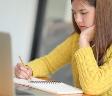 Young college students reviewing lessons to prepare for exams.